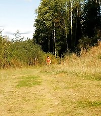 Raunchy young chick pees down the slope of a hill