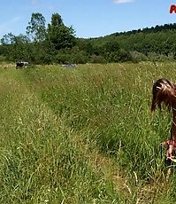 Beautiful teen peeing on the field