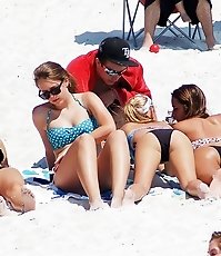 Bikini doll doing blowjob on beach