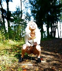 Voyeur shots of a blonde teeny pissing outdoors