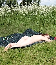 Kinky tart sunbathes nude and tinkles in the field
