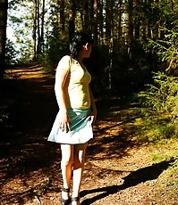 Cute brunette squats down to take a leak in forest