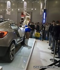 Girls in tiny shorts look great near the luxurious cars