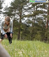 Shameless young tart caught peeing on forest path